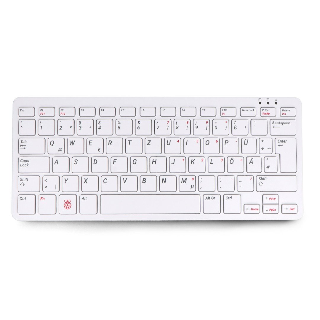 A white keyboard with a built-in raspberry pi 400 computer lies on a white background.