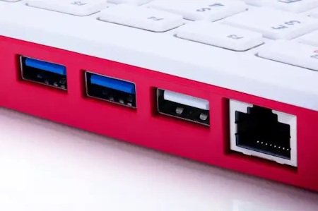 Three USB and one Ethernet outputs built into a pink and white keyboard with a computer.