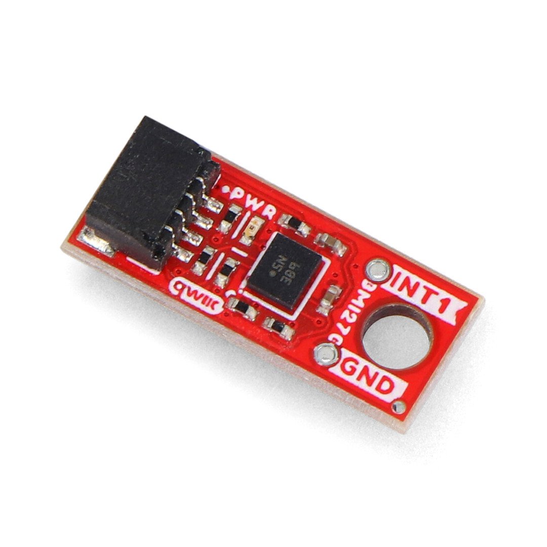 Red sparkfun micro board with accelerometer and gyroscope lies on a white background.