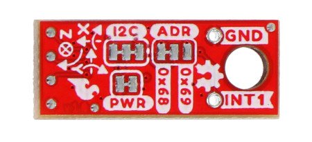 Red sparkfun micro board with accelerometer and gyroscope lies inverted on a white background.