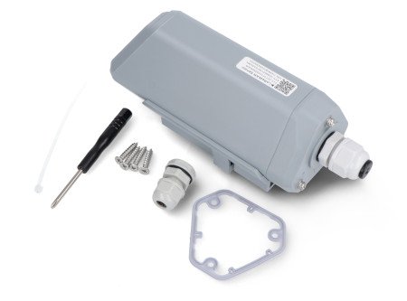 A light gray lorawan data logger lies on a white background along with kit elements.