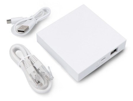 The white Tuya control unit lies on a white background along with the elements of the set.