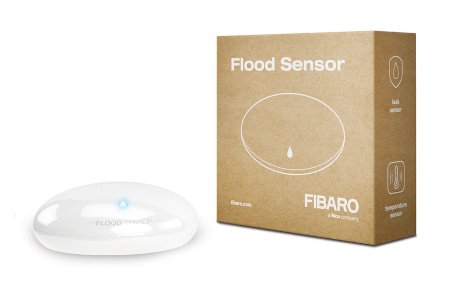 The white and round Fibaro flood sensor lies on a white background with a box.